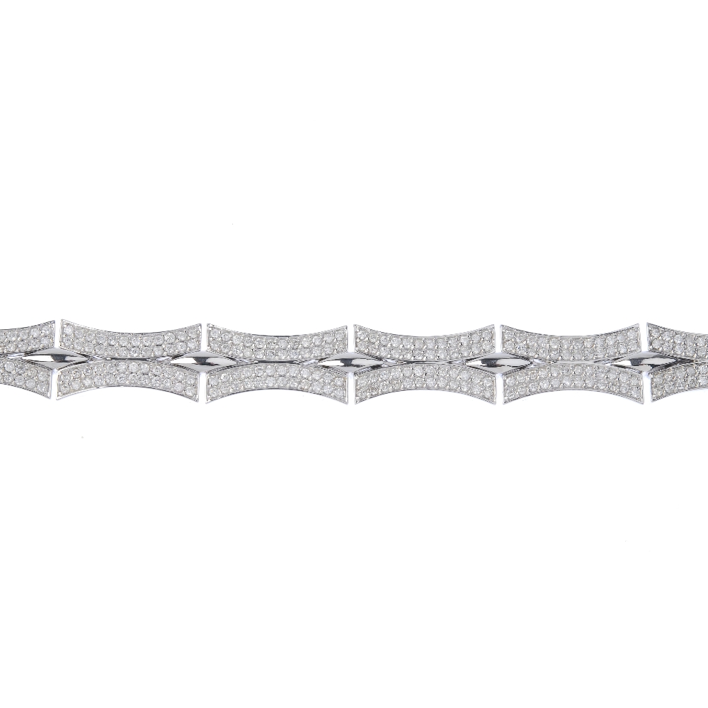(128988) A diamond fancy-link bracelet. Designed as a series of pave-set diamond curved links, to