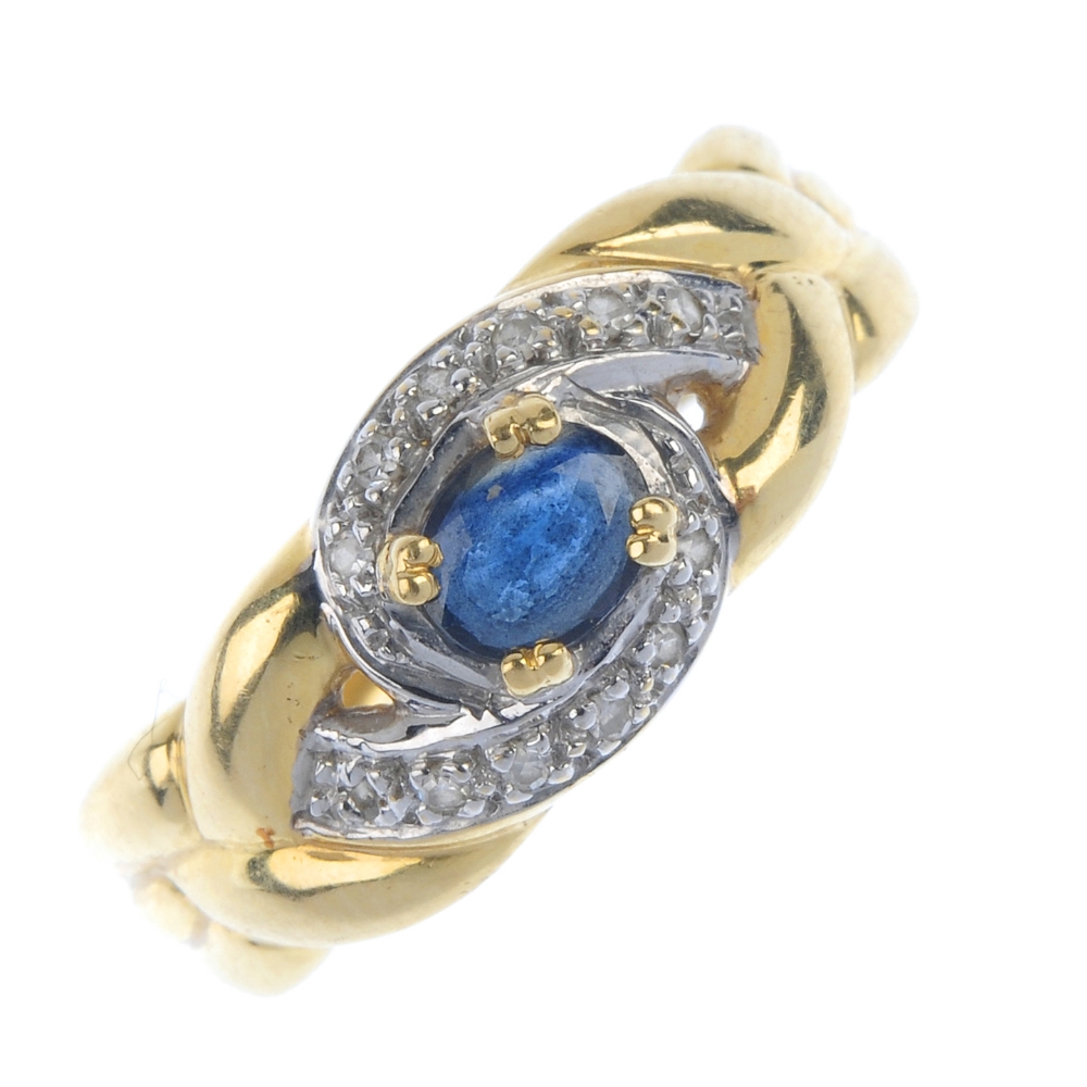 A sapphire and diamond dress ring. The oval-shape sapphire, within a single-cut diamond scrolling