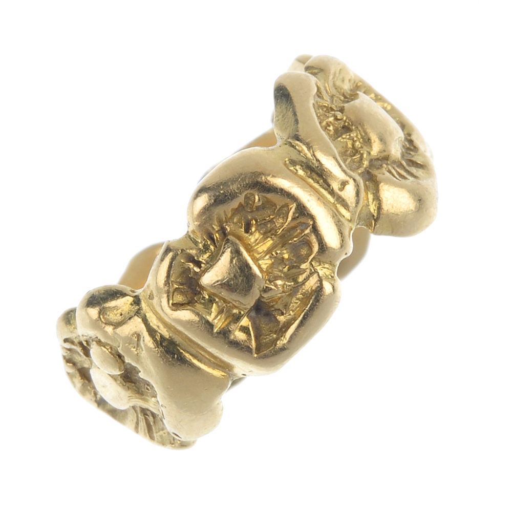 An 18ct gold band ring. Designed as a repeating floral motif. Hallmarks for London. Ring size F.