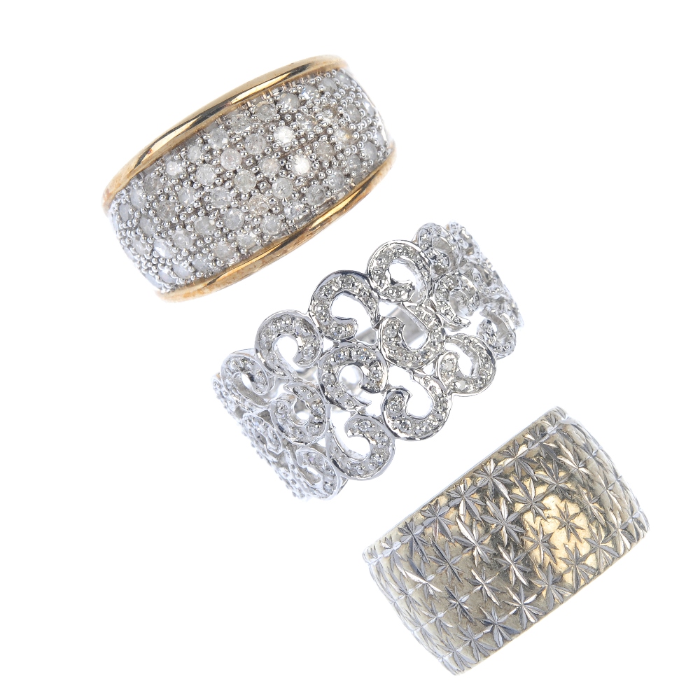 A selection of three 9ct gold rings. To include a diamond openwork scrolling ring, a diamond panel