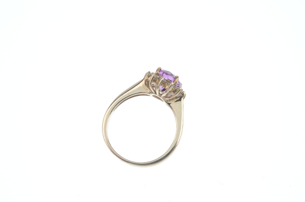 A 9ct gold coated topaz and diamond cluster ring.The oval-shape pink coated topaz and brilliant- - Image 3 of 3