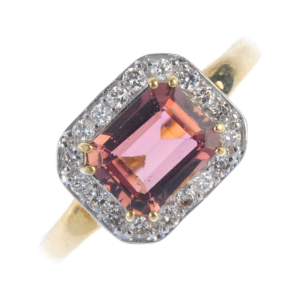A topaz dress ring. The pink topaz, within a brilliant-cut diamond surround, to the tapered band.