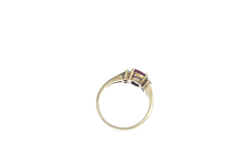 A ruby and diamond ring. The circular-shape ruby, to the brilliant-cut diamond sides and - Image 3 of 3