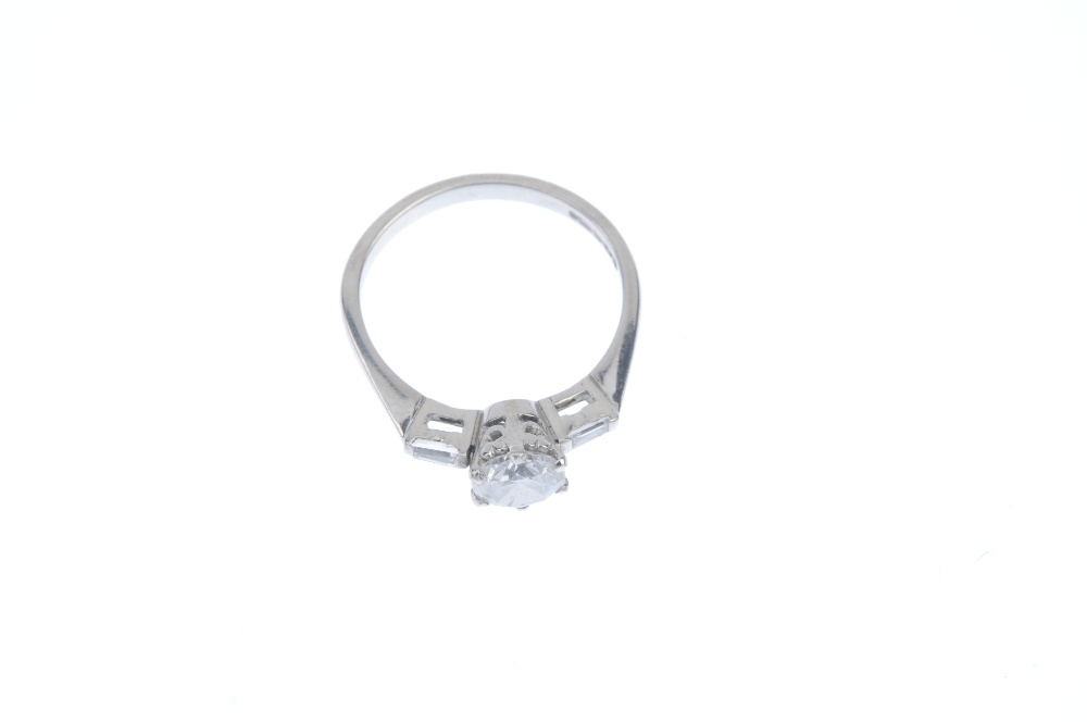 An 18ct gold diamond single-stone ring. The brilliant-cut diamond, to the tapered baguette-cut - Image 2 of 3