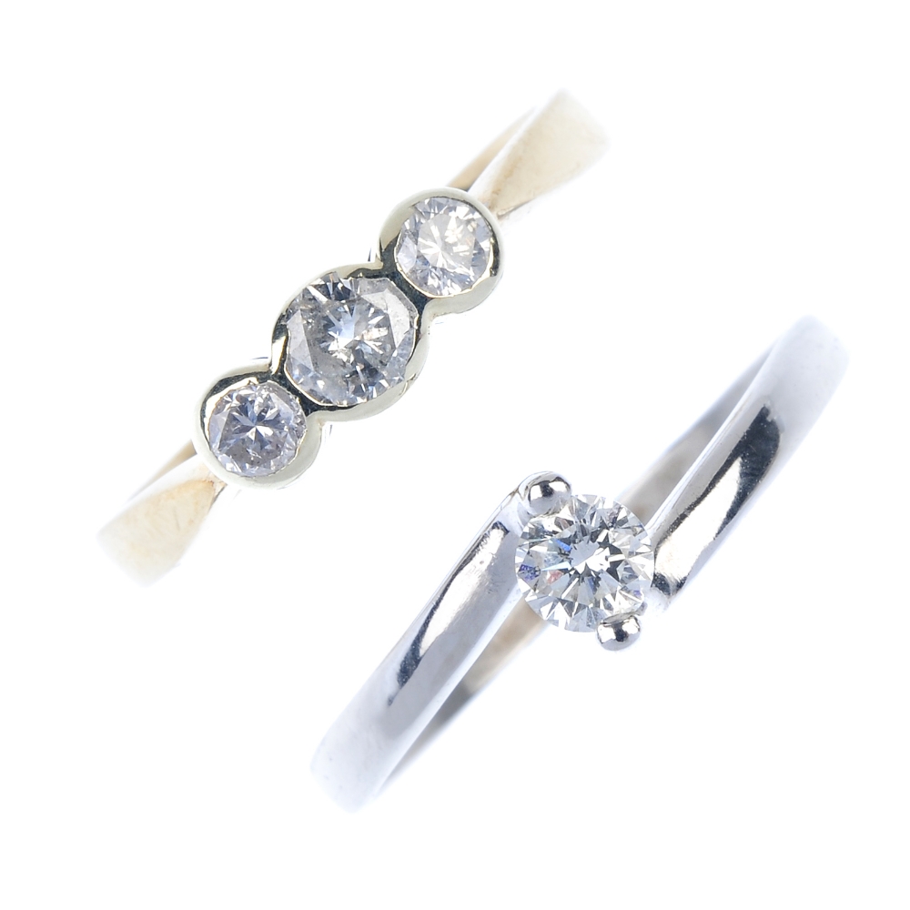 Two 9ct gold diamond dress rings. To include a brilliant-cut diamond single-stone crossover ring and