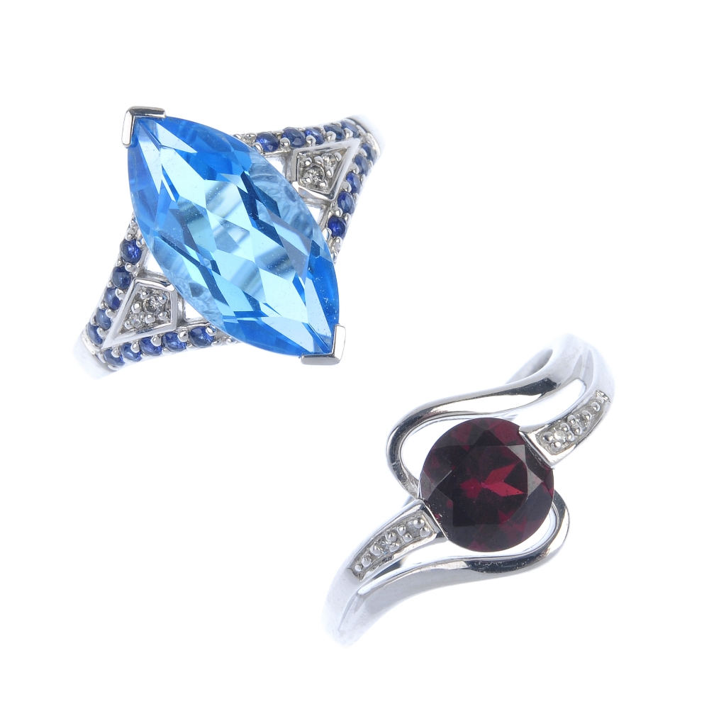 A selection of three 9ct gold gem-set rings. To include a garnet and colourless gem half-circle