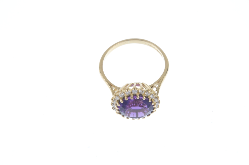 An 18ct gold amethyst and diamond cluster ring. The circular-shape amethyst, within a brilliant- - Image 2 of 3