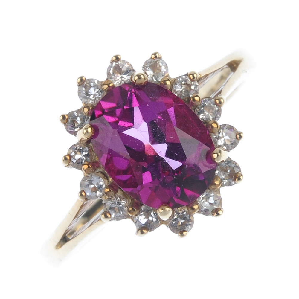 A 9ct gold coated topaz and diamond cluster ring.The oval-shape pink coated topaz and brilliant-