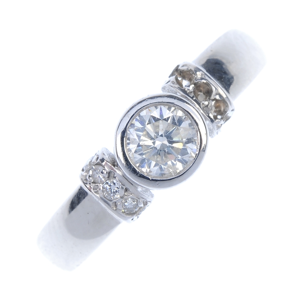 An 18ct gold diamond single-stone ring. The brilliant-cut diamond collet, to the brilliant-cut