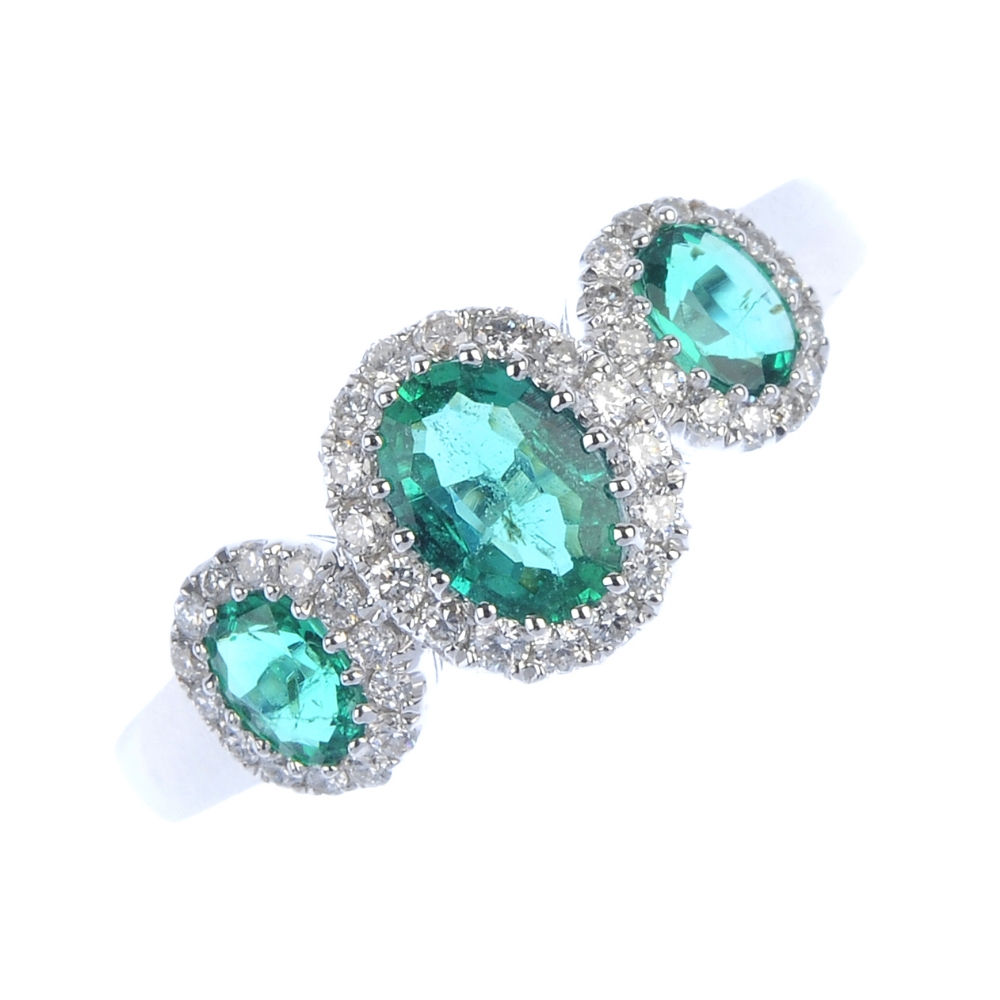 * An emerald and diamond triple cluster ring. The three oval-shape emeralds, each within a