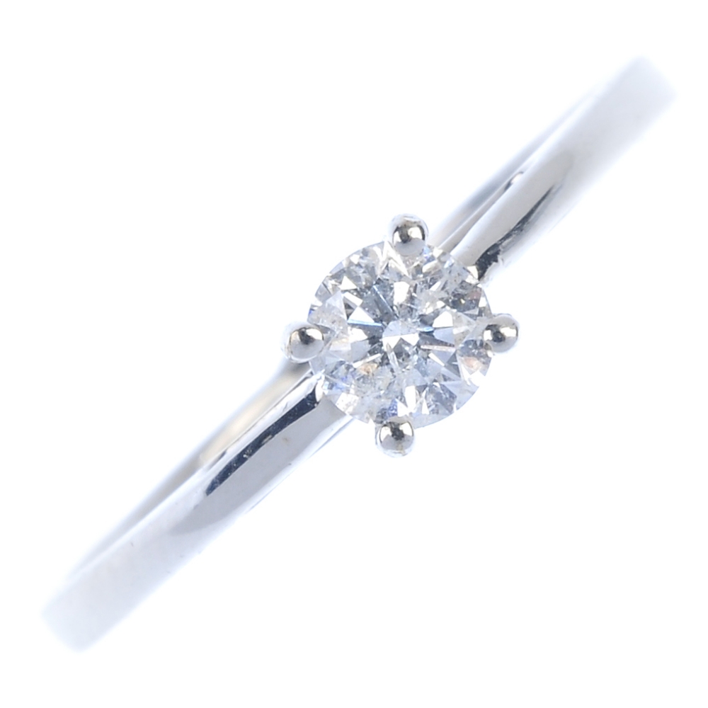 A 9ct gold diamond single-stone ring. The brilliant-cut diamond, to the tapered shoulders and