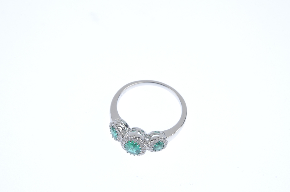 * An emerald and diamond triple cluster ring. The three oval-shape emeralds, each within a - Image 2 of 3