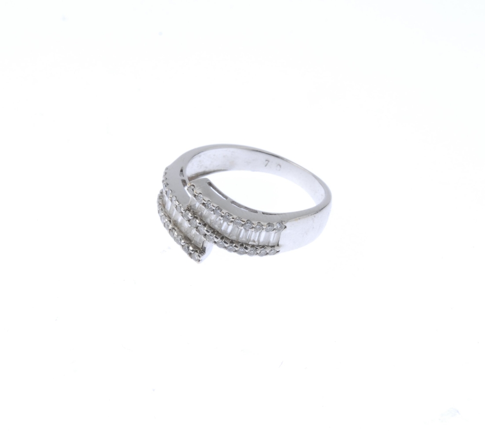 (187921) A diamond crossover ring. Designed as two rows of baguette-cut diamonds within a channel of - Image 3 of 4