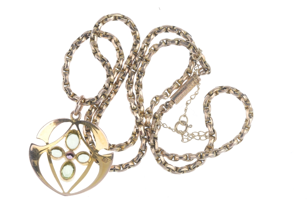 An early 20th century gem-set pendant. The circular-shape garnet, within an oval-shape peridot - Image 2 of 2