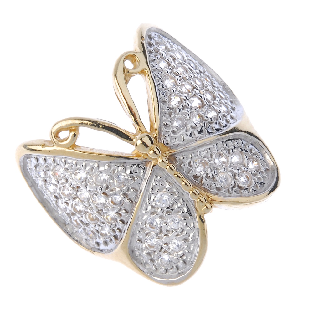 A 9ct gold paste butterfly ring. The circular-shape colourless paste butterfly, to the bifurcated