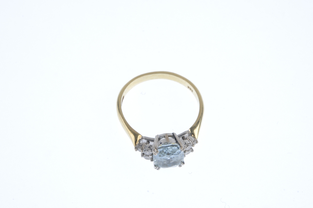 An 18ct gold aquamarine and diamond dress ring. The cushion-shape aquamarine, with brilliant-cut - Image 2 of 3