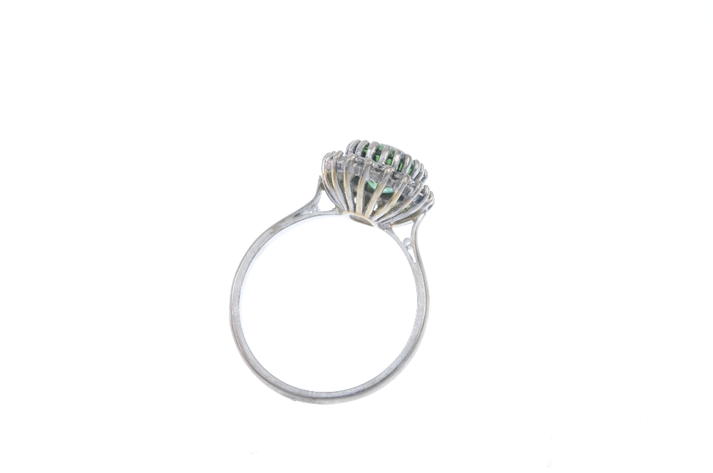 A tourmaline and diamond cluster ring. The oval-shape green tourmaline, within a single-cut - Image 3 of 3