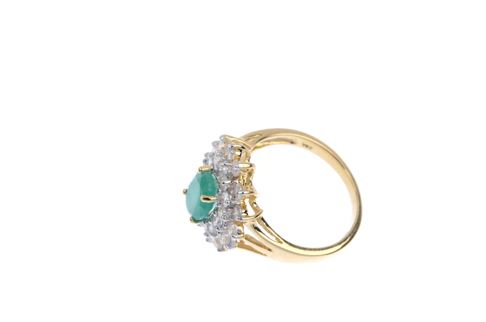 An 18ct gold emerald and diamond cluster ring. The oval-shape emerald, within a brilliant-cut - Image 3 of 4