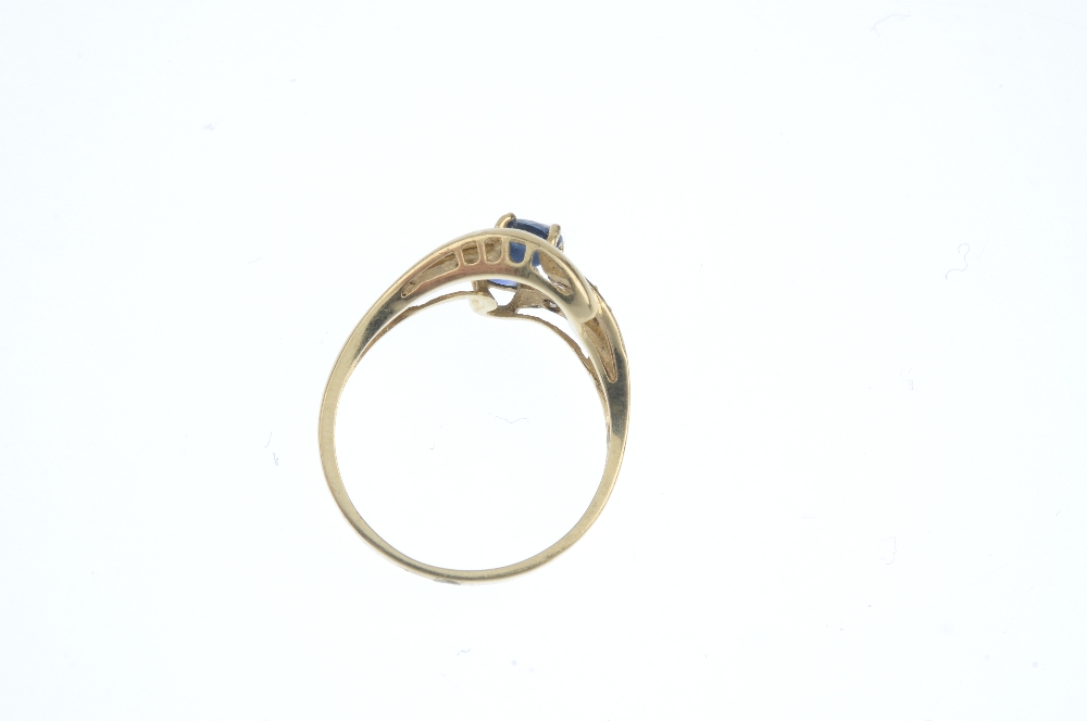 A sapphire and diamond dress ring. The oval-shape sapphire and brilliant-cut diamond scrolling band, - Image 3 of 3