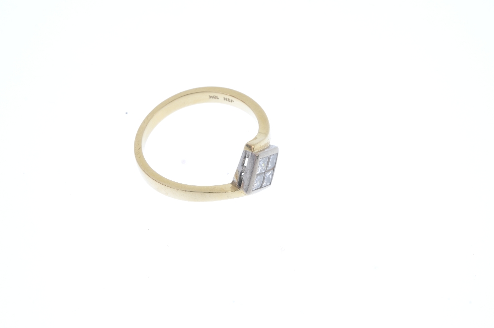 An 18ct gold diamond four-stone ring. The square-shape diamond panel, with crossover shoulders and - Image 3 of 4