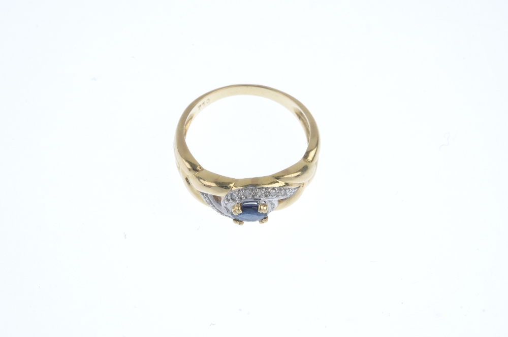 A sapphire and diamond dress ring. The oval-shape sapphire, within a single-cut diamond scrolling - Image 2 of 3