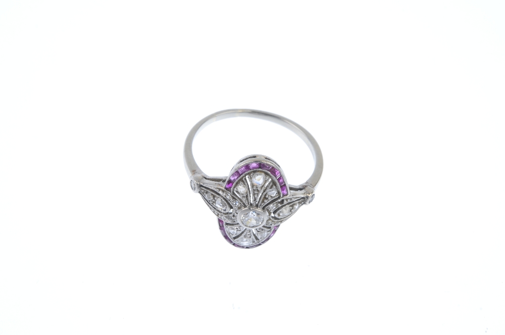 A diamond and ruby dress ring. The circular-cut diamond collet, within a rose-cut diamond pierced - Image 2 of 3