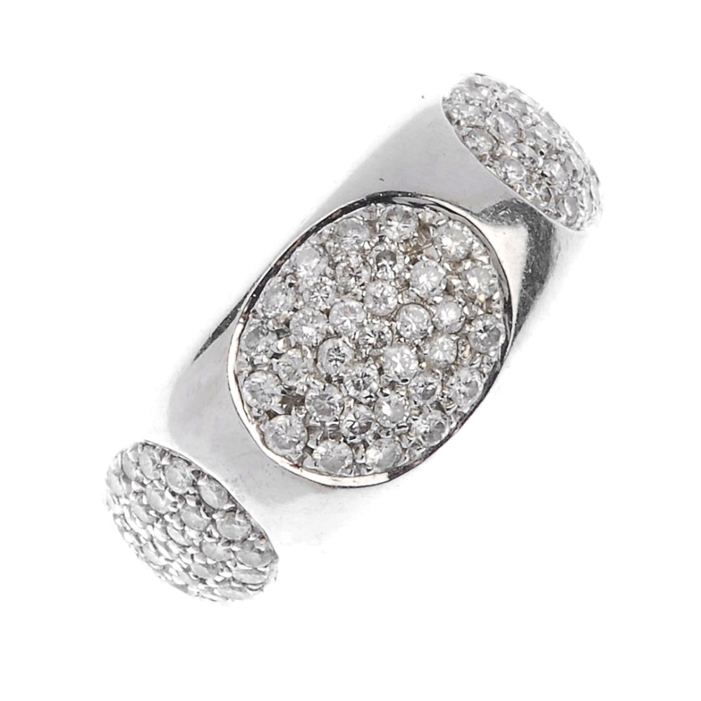 (117589) Two diamond dress rings. The first designed as a pave-set diamond panel to the