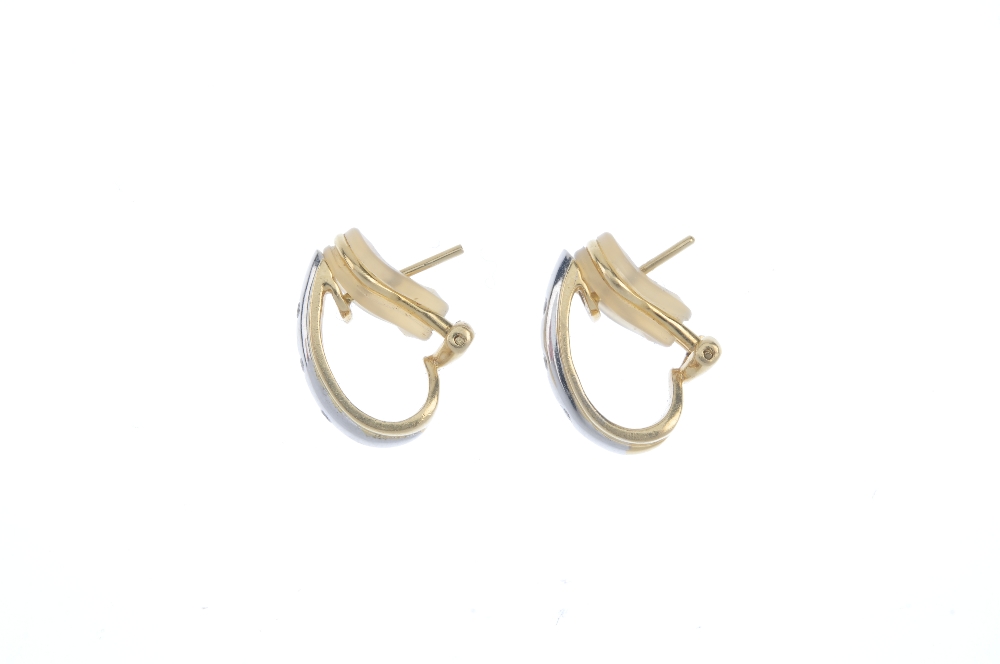 A pair of 18ct gold diamond earrings. Each of bi-colour design, the ridged half-hoop with - Image 2 of 2