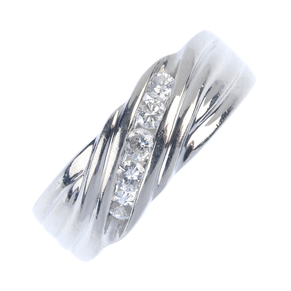 A platinum diamond dress ring. The brilliant-cut diamond diagonal line, with grooved sides and