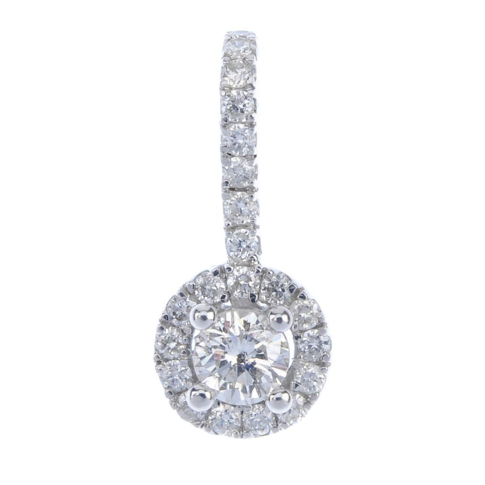 An 18ct gold diamond pendant. The brilliant-cut diamond, raised to the similarly-cut diamond