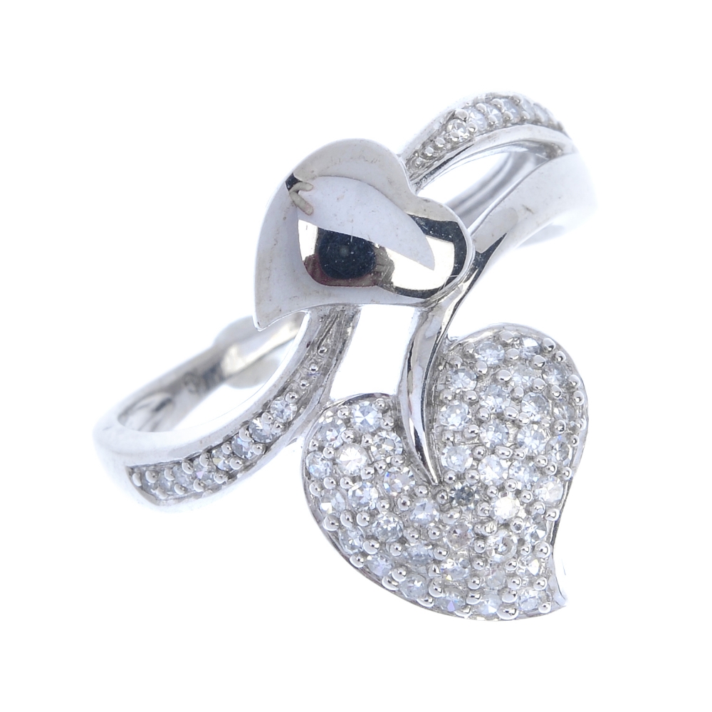 A diamond dress ring. Of foliate design, the pave-set diamond and polished stylised leaves, with