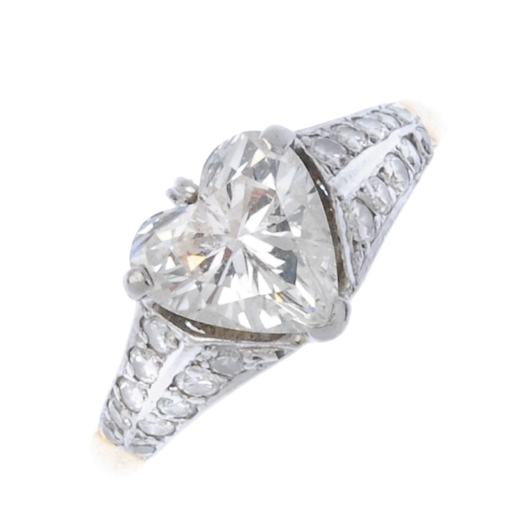 (187921) An 18ct gold diamond single-stone ring. The heart-shape diamond to the graduated