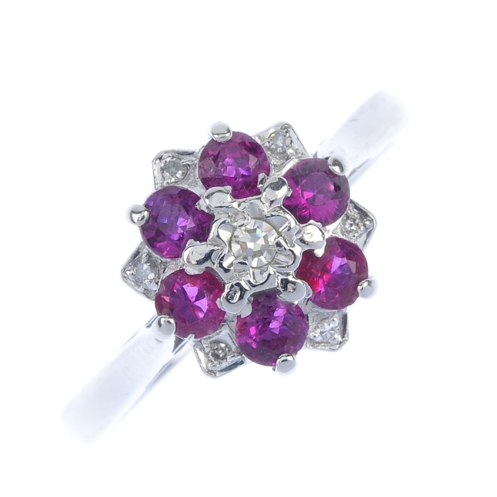 An 18ct gold ruby and diamond floral cluster ring. The single-cut diamond, within a circular-shape