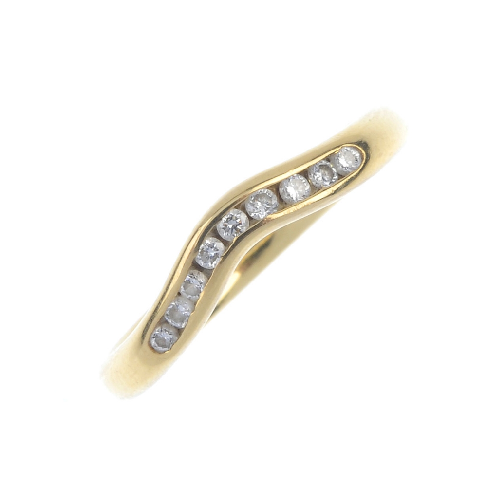 An 18ct gold diamond half-circle eternity ring. Designed as a channel-set brilliant-cut diamond