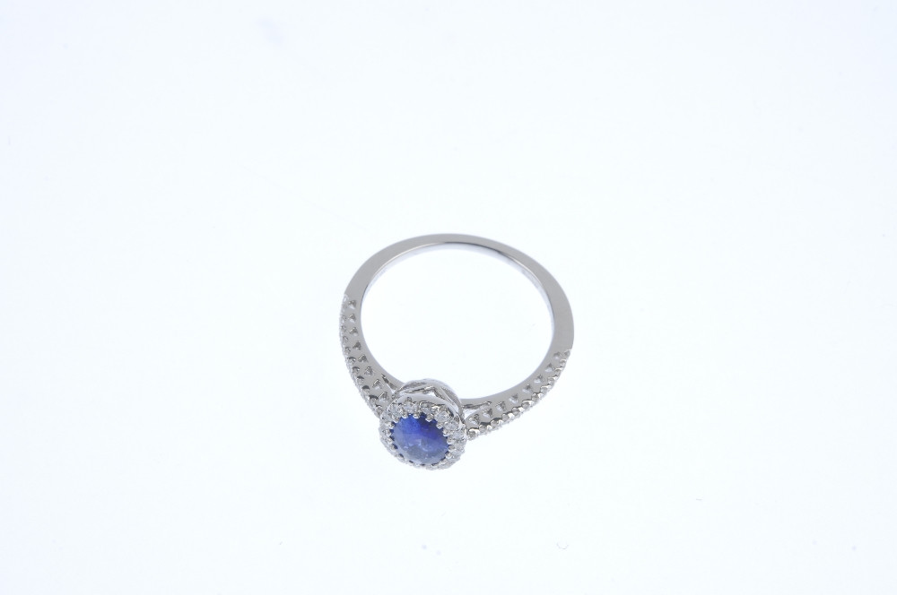 * An 18ct gold sapphire and diamond cluster ring. The oval-shape sapphire, within a brilliant-cut - Image 2 of 3