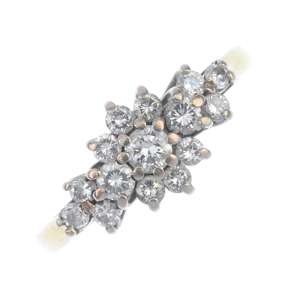 An 18ct gold diamond floral cluster ring. The brilliant-cut diamond cluster, with similarly-cut