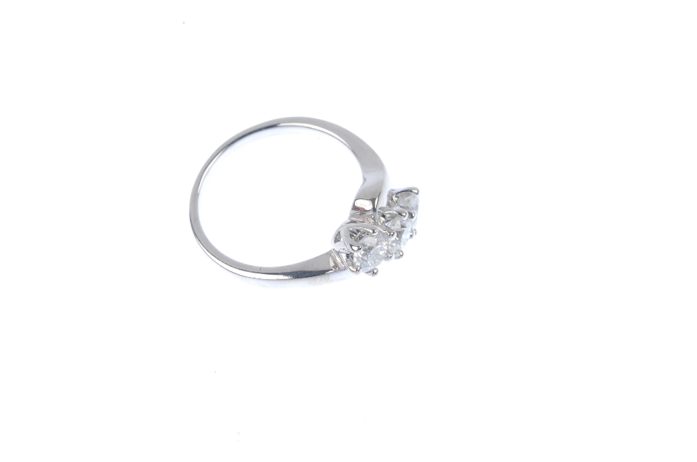 An 18ct gold diamond three-stone crossover ring. The brilliant-cut diamond diagonal line, to the - Image 3 of 4