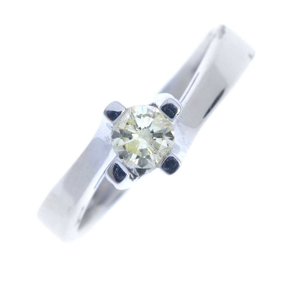 A 14ct gold diamond single-stone ring. The brilliant-cut diamond, to the spiral claw mount and