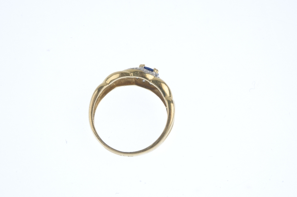 A sapphire and diamond dress ring. The oval-shape sapphire, within a single-cut diamond scrolling - Image 3 of 3