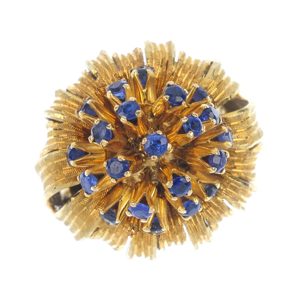 A mid 20th century 18ct gold sapphire flower ring. The circular-shape sapphire spray, within a