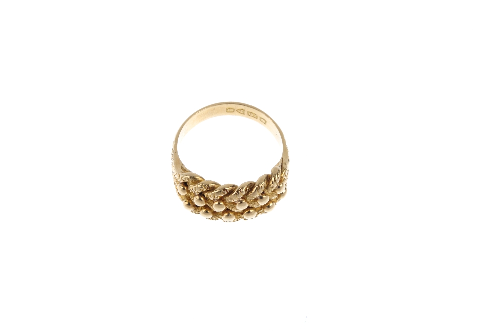 An Edwardian 18ct gold keeper ring. The bead highlight and vari-texture interwoven panel, to the - Image 2 of 3