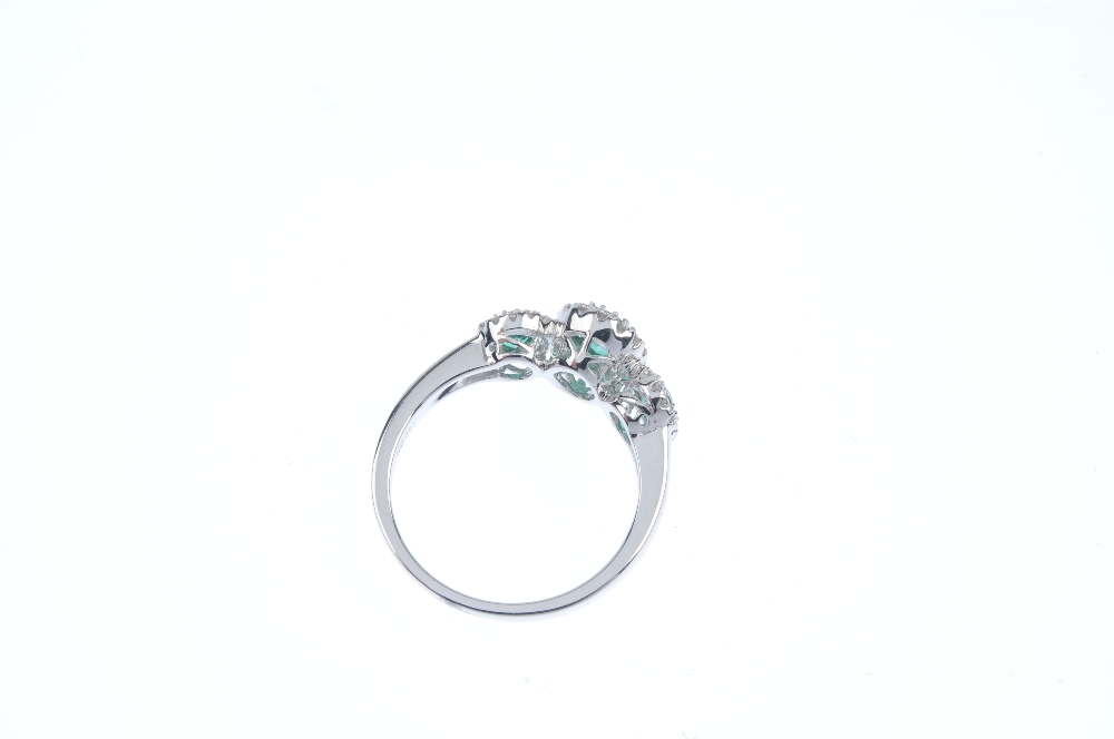* An emerald and diamond triple cluster ring. The three oval-shape emeralds, each within a - Image 3 of 3