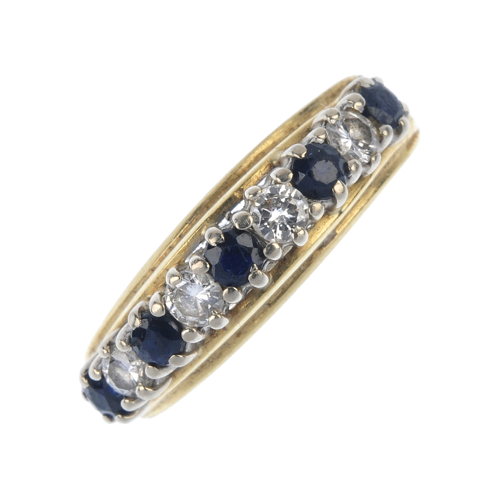 A sapphire and diamond half-circle eternity ring. The alternating circular-shape sapphire and