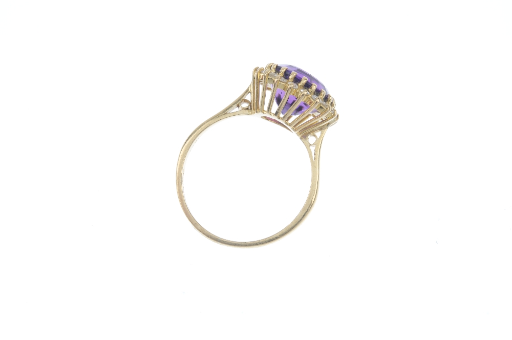 An 18ct gold amethyst and diamond cluster ring. The circular-shape amethyst, within a brilliant- - Image 3 of 3