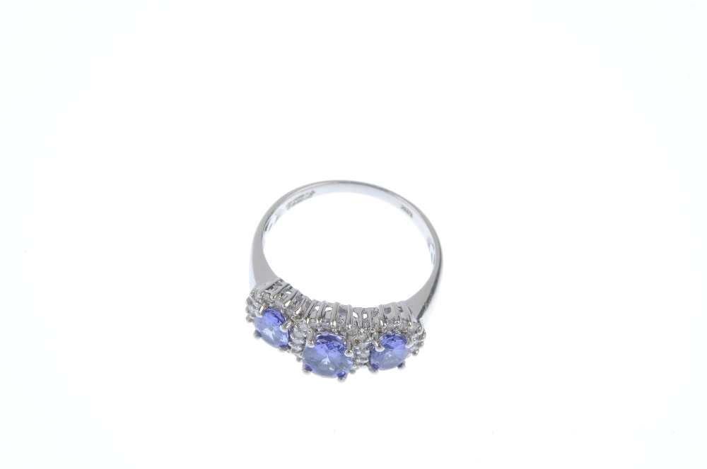 An 18ct gold tanzanite and diamond triple cluster ring. The slightly graduated oval-shape - Image 2 of 3