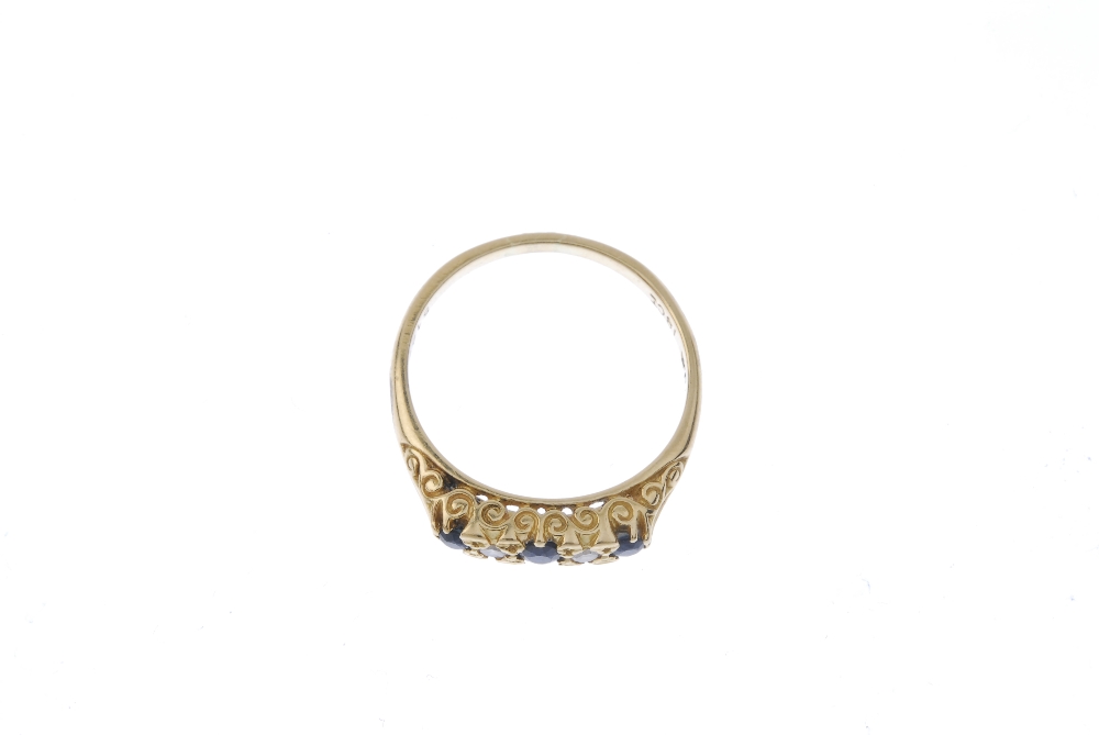 A sapphire and diamond five-stone ring. The alternating graduated circular-shape sapphire and - Image 2 of 3