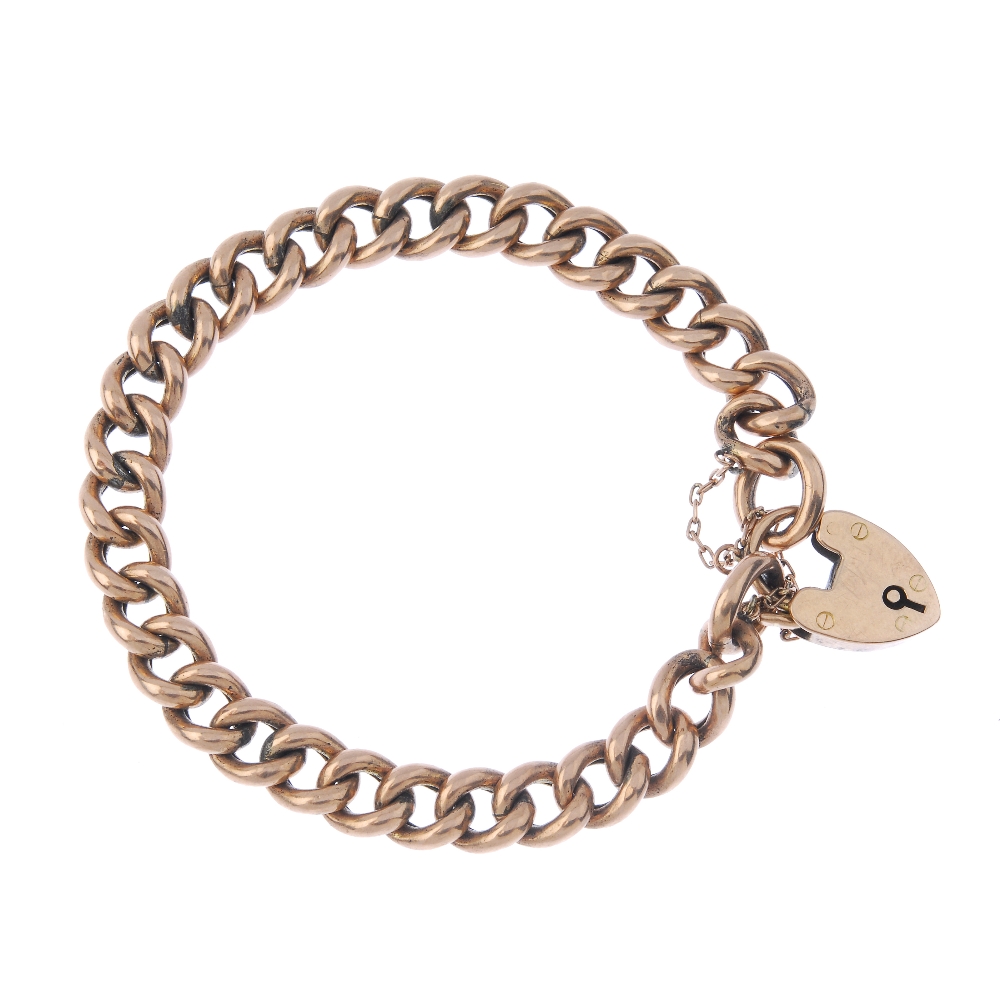 An early 20th century 9ct gold bracelet. The curb-link chain, to the heart-shape padlock clasp.