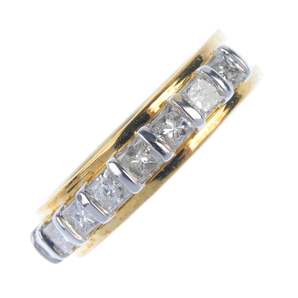 A 9ct gold diamond band ring. Designed as a series of square-shape diamonds, to the ridged band.