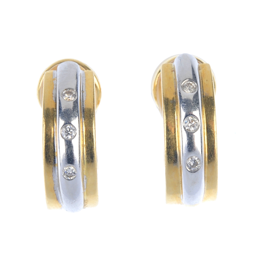 A pair of 18ct gold diamond earrings. Each of bi-colour design, the ridged half-hoop with