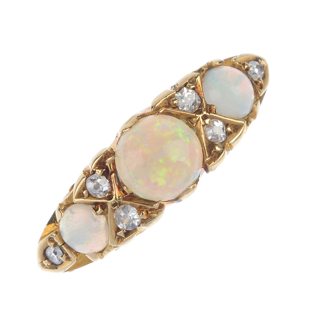 An Edwardian opal and diamond ring. The graduated circular opal cabochon line, with old-cut